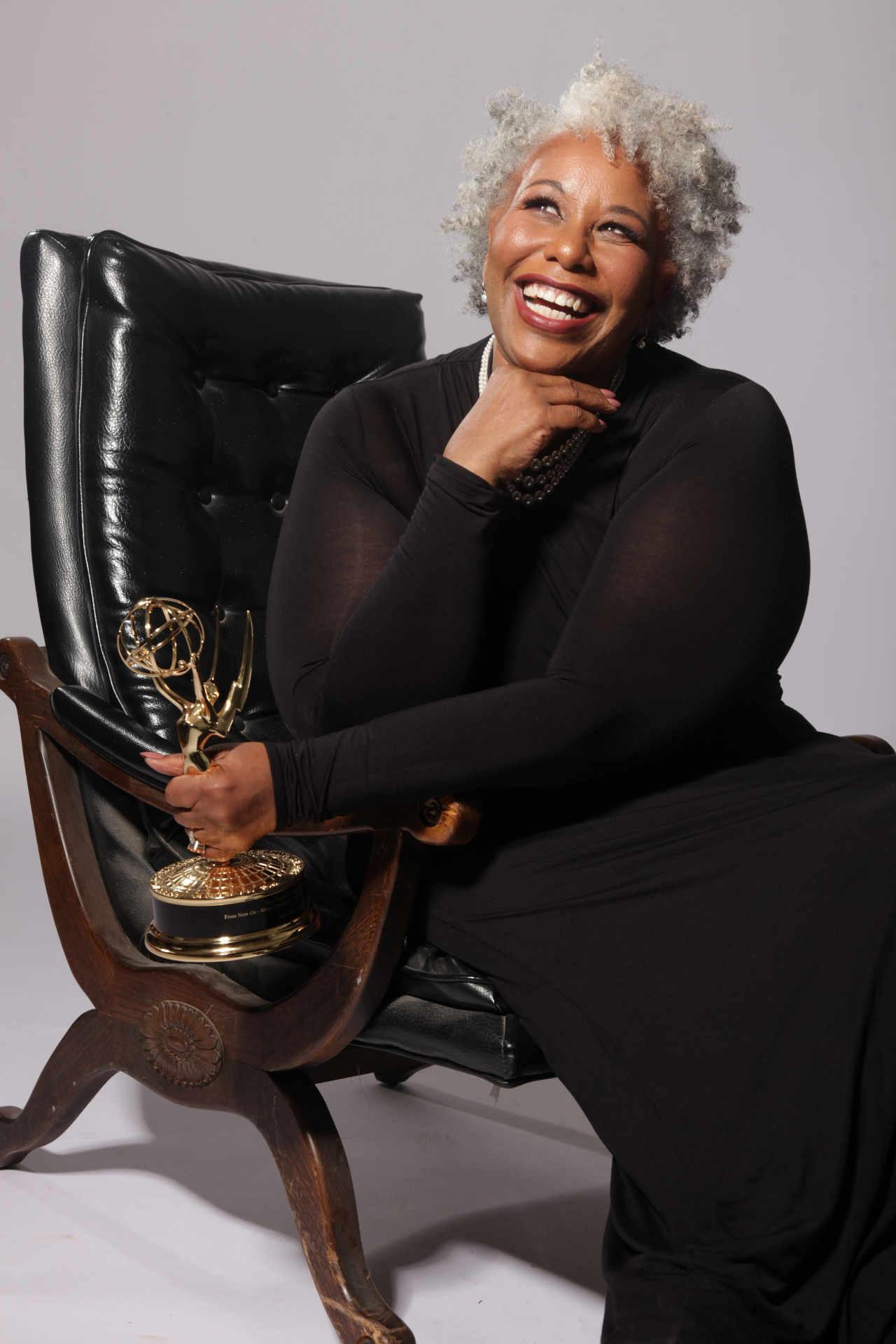 Karynn Wright-Hough, Founder of FreshTalent Group, holding her Emmy Award